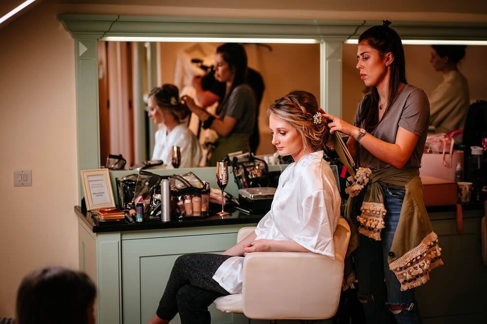 Micklefield Hall wedding, bride having her hair done in bridal suite