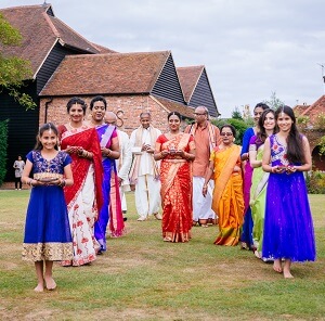 Micklefield Hall Indian wedding, bride walking with her bridesmaids in Indian wedding dress