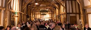 charity fundraiser guests at tables in great barn