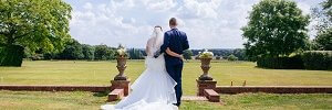 Micklefield Hall wedding, bride and groom stood on rolling lawns
