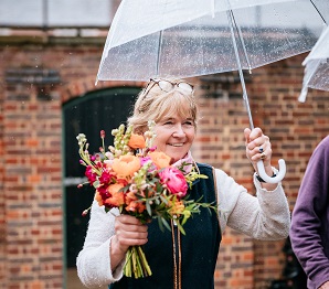 lady holding flowers and umbrella